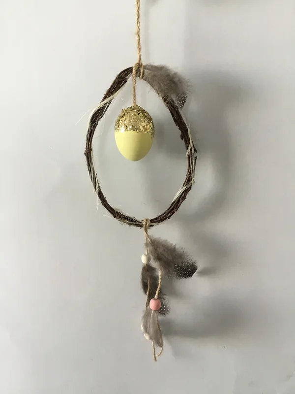 Twig hanger with egg and feather