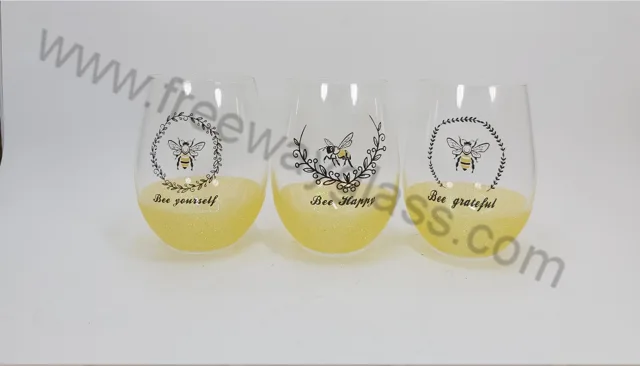 Stemless wine glass with decal and yellow glitter