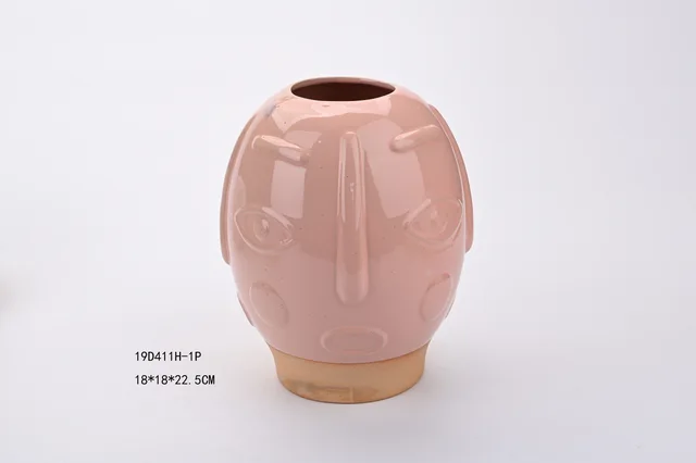Reactive glazed face follower pot